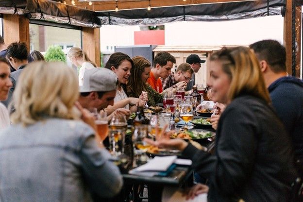 Tourists dining at a French market where they practice normal French conversations