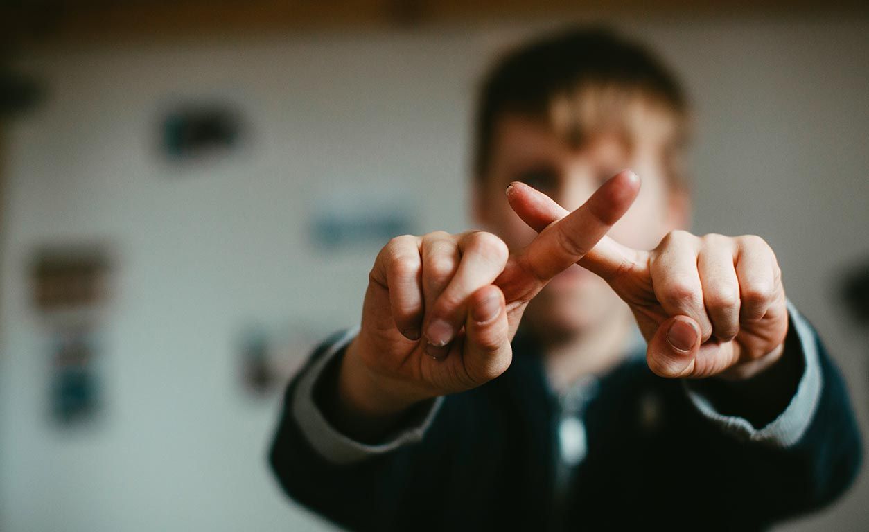 Boy making a sign of disagreement