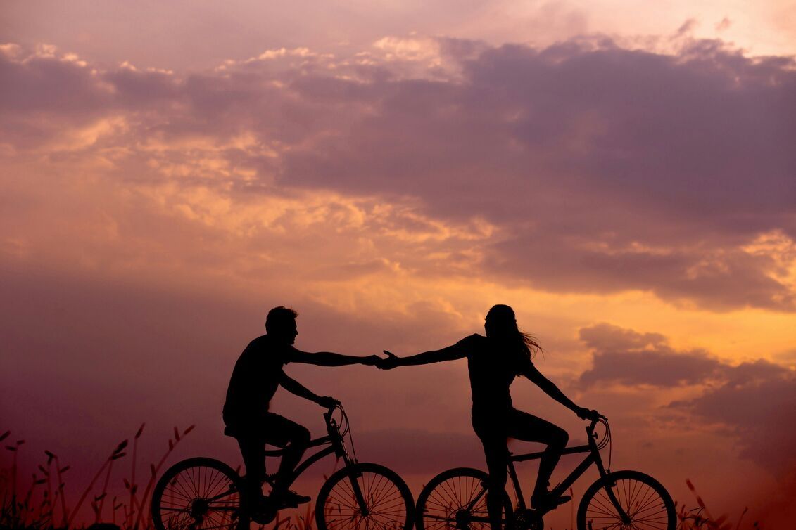 Couple on bike ride at sunset